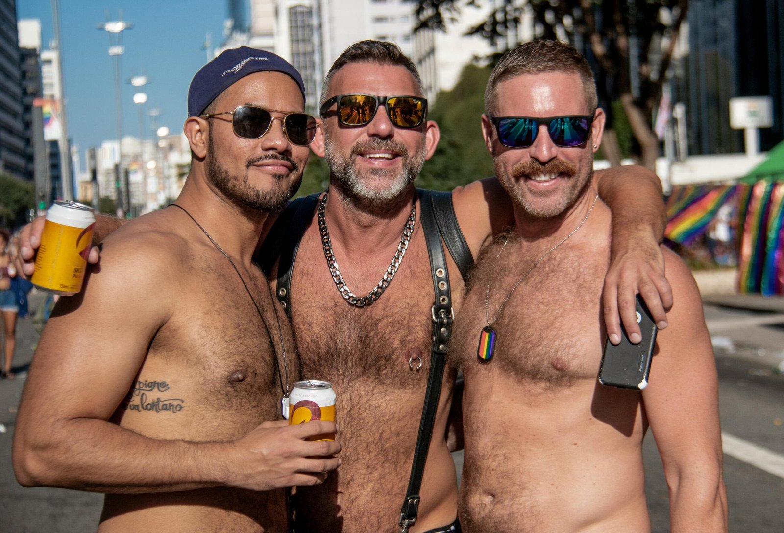 Three men celebrating LGBT pride outdoors in São Paulo, Brazil.