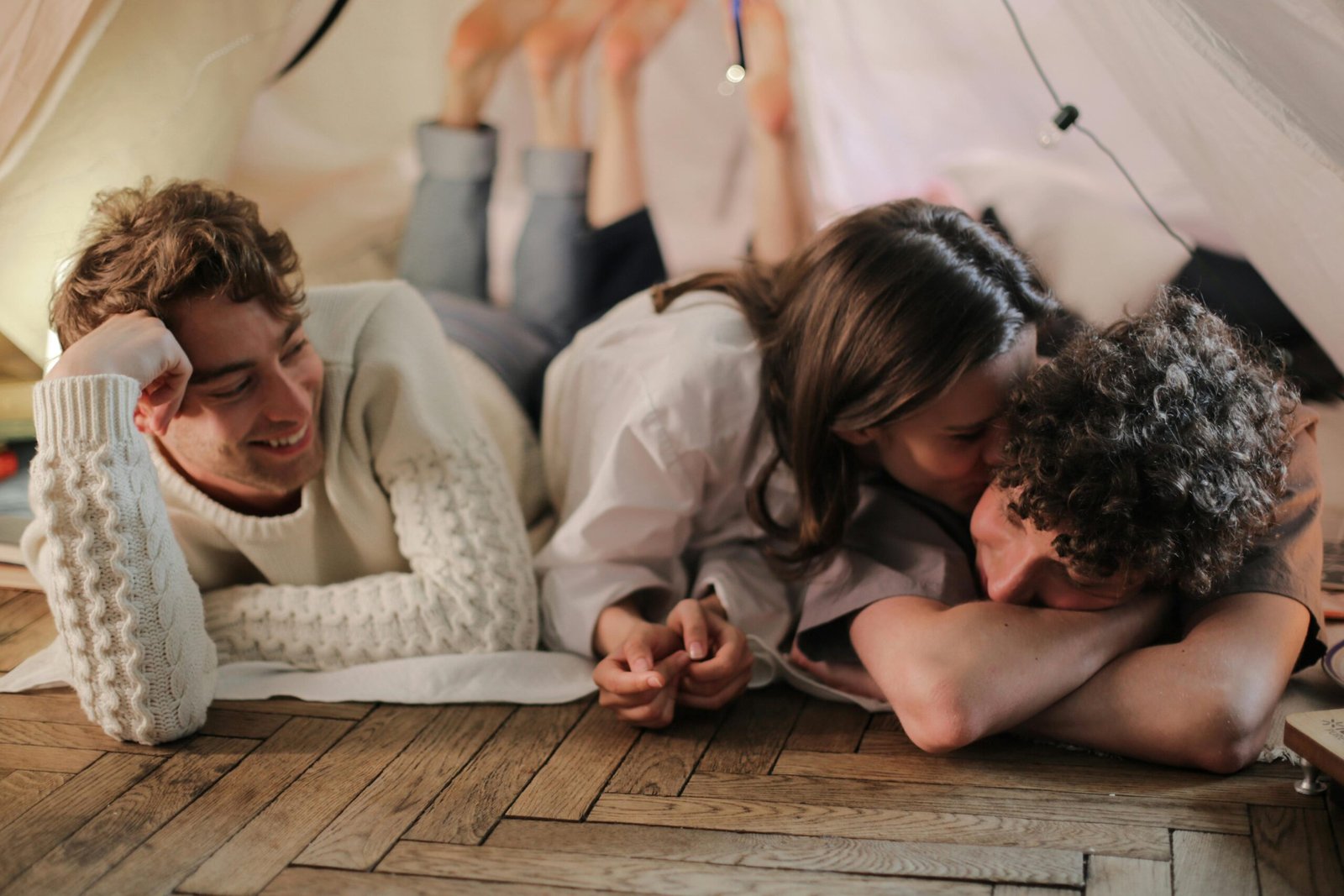 A joyful group of friends relaxing indoors, showcasing warmth and friendship.